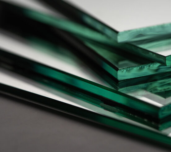 close up view of mirror pieces in stack on dark background